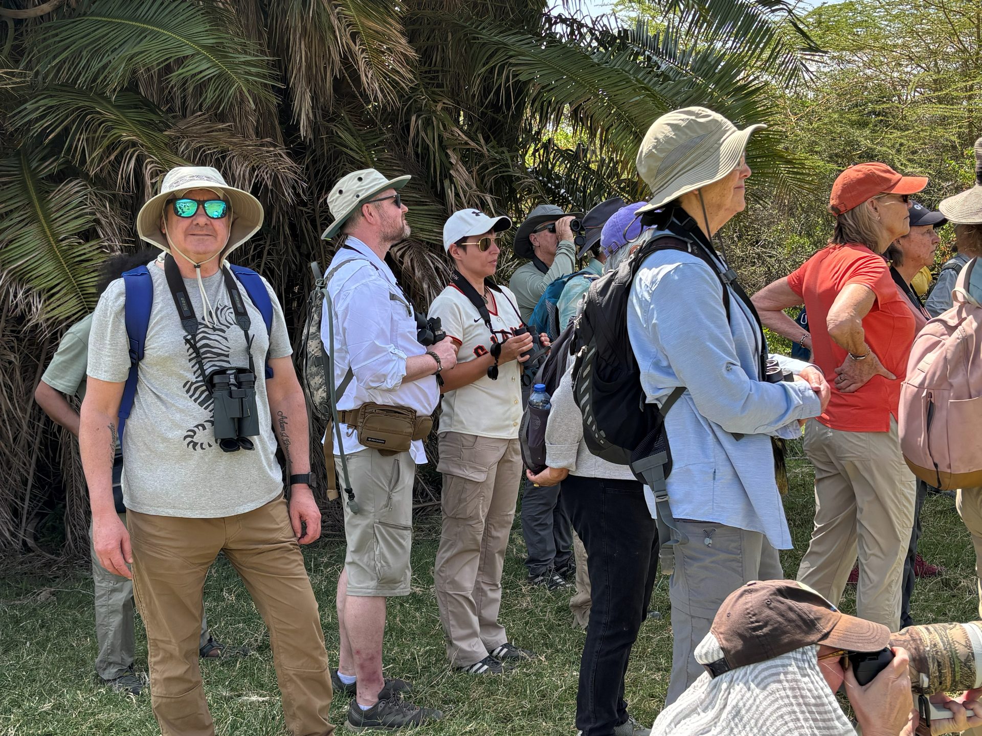 Safari group watching wildlife with binoculars in Arusha National Park